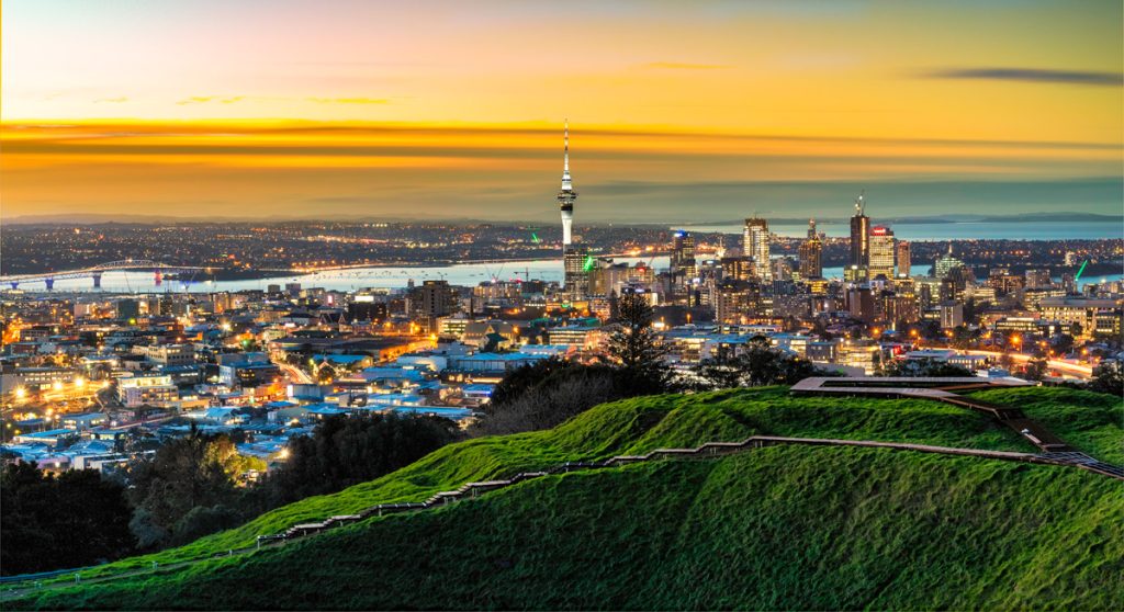 Auckland city skyline with the iconic Sky Tower rising above the waterfront in New Zealand
