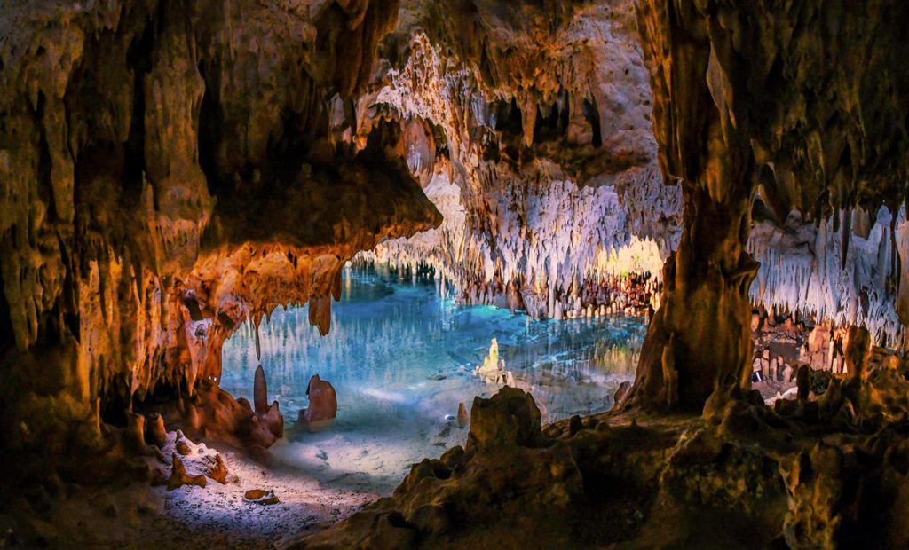 Cayman Crystal Caves, Grand Cayman — dramatic stalactites and an emerald underground lake on the North Side, a must-see guided cave tour.
