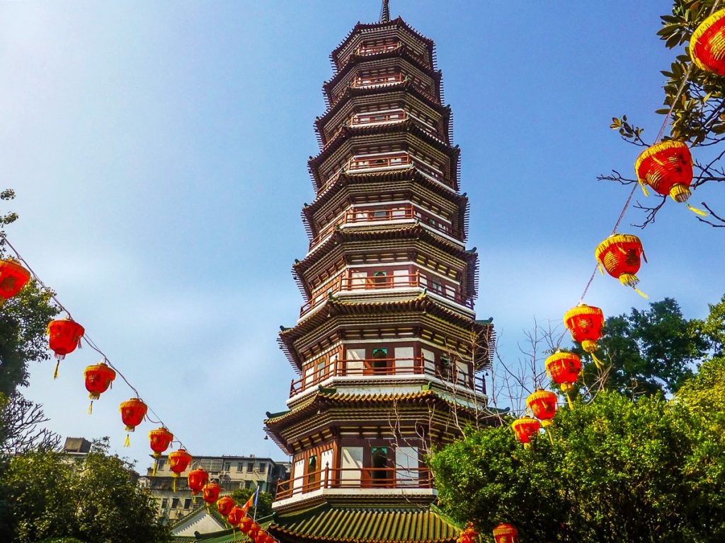 Majestic banyan trees framing a historic temple in Guangzhou.