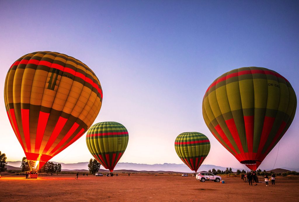 Hot air balloons flying over Marrakech at sunrise