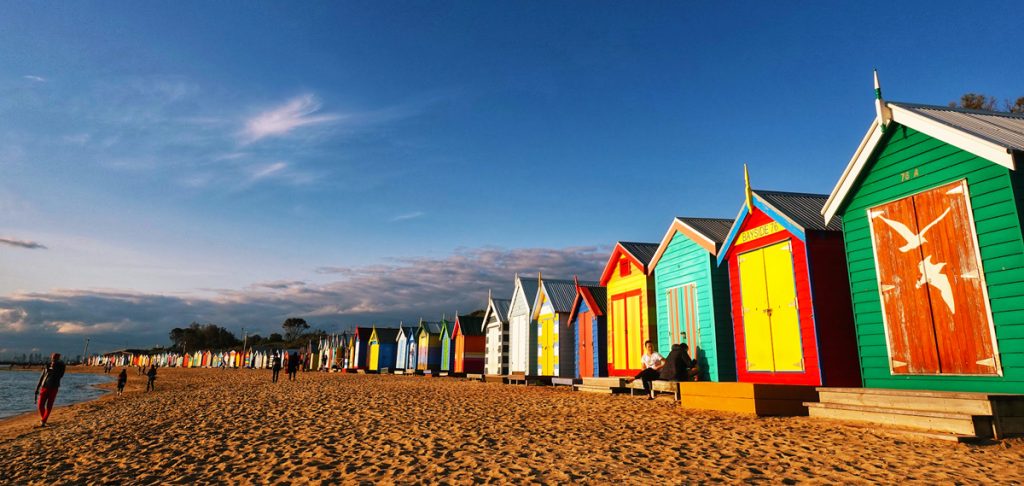 Brighton Beach Boxes – colorful bathing huts with a view of the city skyline