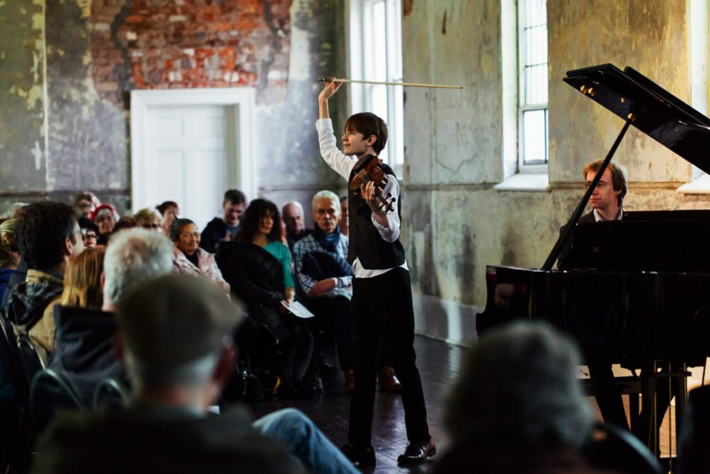 Musical performance at Abbotsford Convent – a transformed historic site housing artist studios, cafes, and gardens.