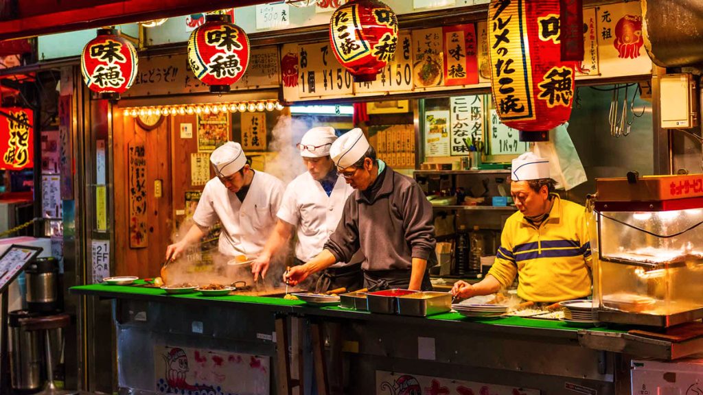 Street food in Osaka, from sizzling takoyaki to savory okonomiyaki.