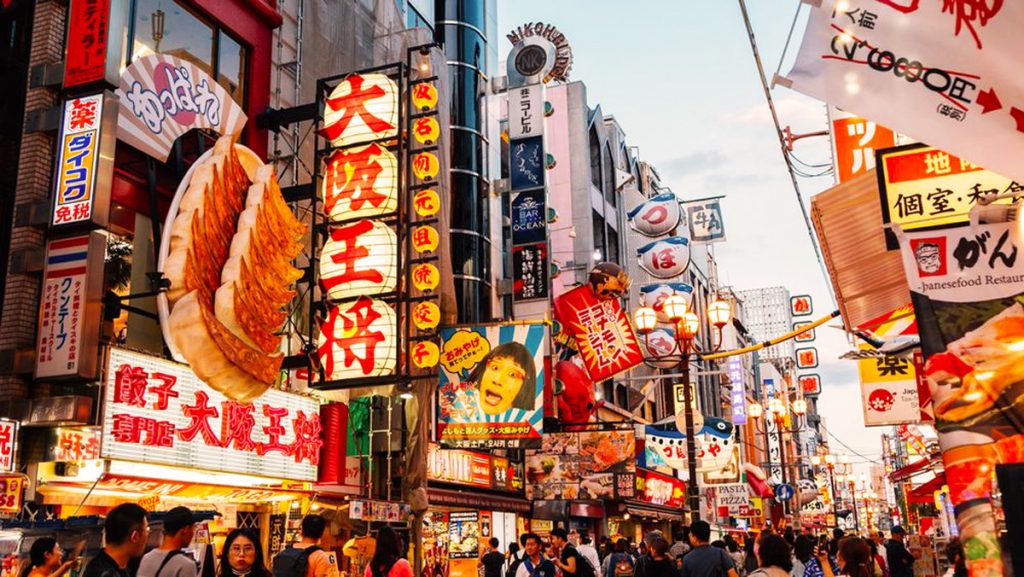 Bustling street in Osaka filled with shops, signs, and local energy