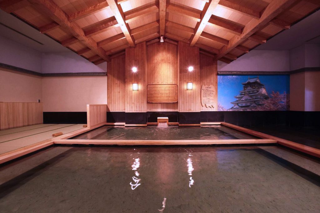 Indoor pool area at Spa World Osaka, combining relaxation and fun